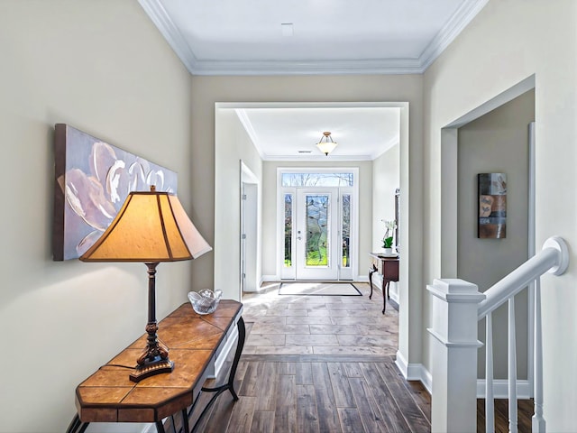 entryway featuring ornamental molding, wood finished floors, and baseboards