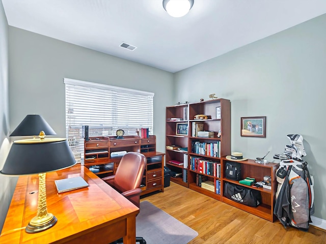 office with visible vents and wood finished floors