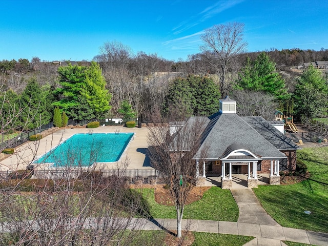 view of swimming pool with a patio, a lawn, fence, and a fenced in pool