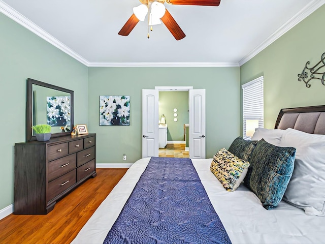 bedroom with dark wood-type flooring, crown molding, and baseboards