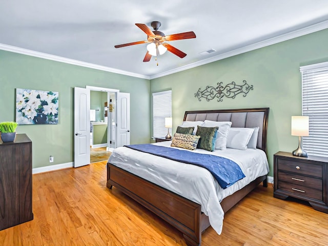 bedroom featuring ornamental molding, light wood-type flooring, a ceiling fan, and baseboards