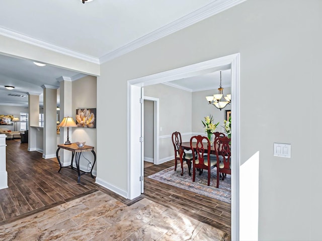 dining space with baseboards, wood finish floors, and crown molding