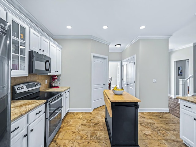 kitchen with butcher block countertops, glass insert cabinets, fridge, double oven range, and black microwave