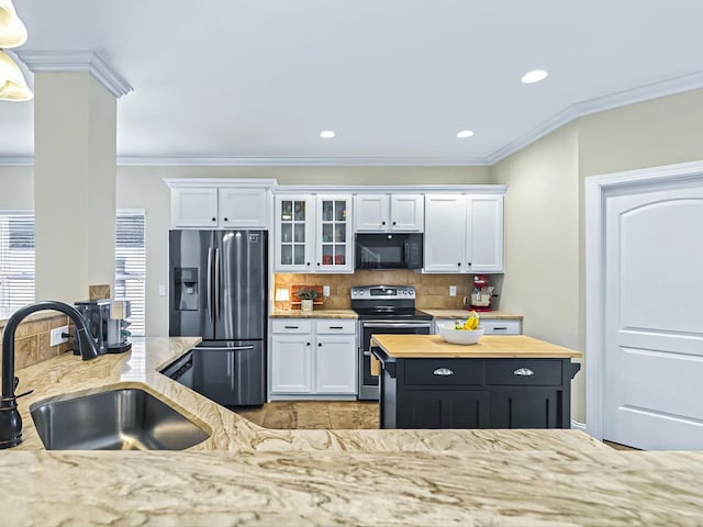 kitchen featuring stainless steel appliances, white cabinets, a sink, and glass insert cabinets