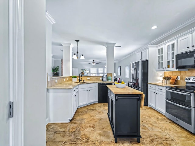 kitchen with black appliances, butcher block countertops, a sink, and white cabinets