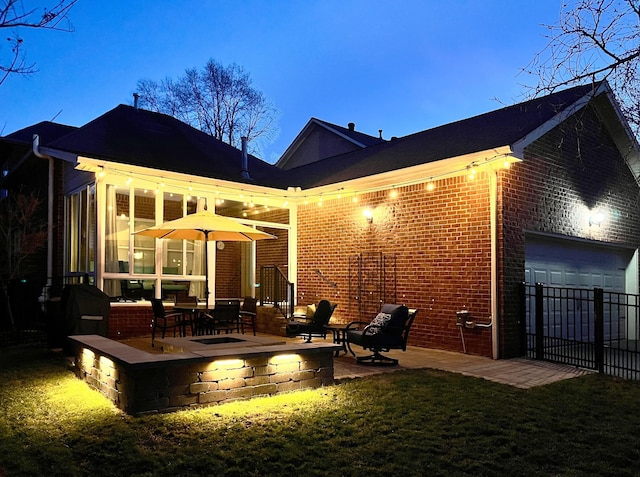 rear view of house featuring fence, a patio, and brick siding