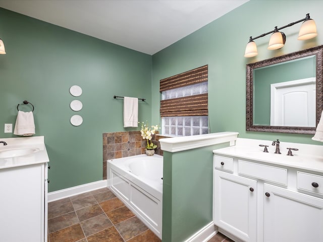 full bath featuring a bath, two vanities, and a sink