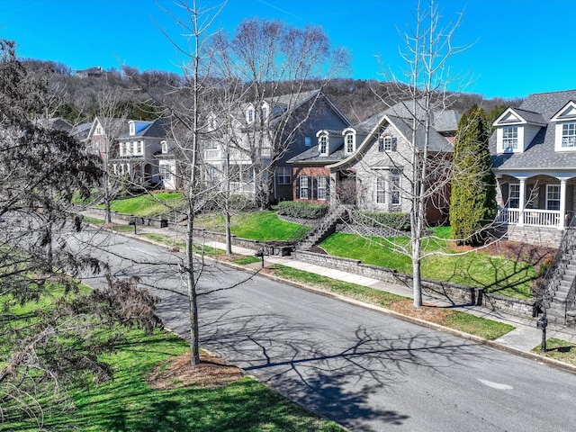 exterior space with sidewalks, a residential view, and curbs