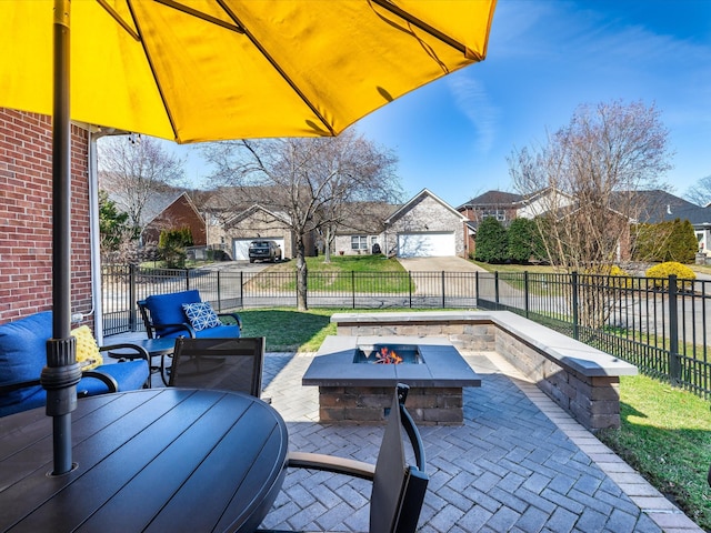 view of patio with an outdoor fire pit, a residential view, outdoor dining area, and a fenced backyard