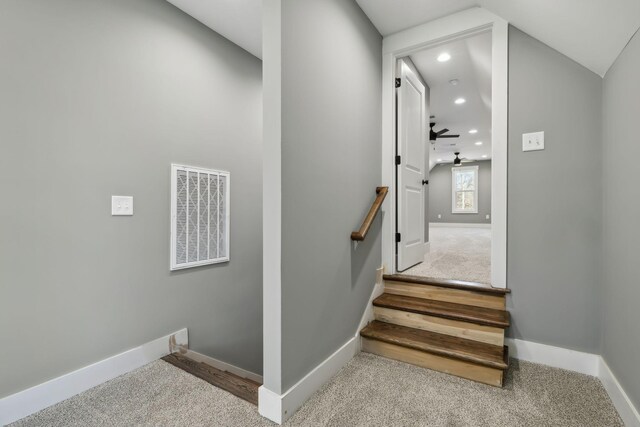 stairway with baseboards, visible vents, and carpet flooring