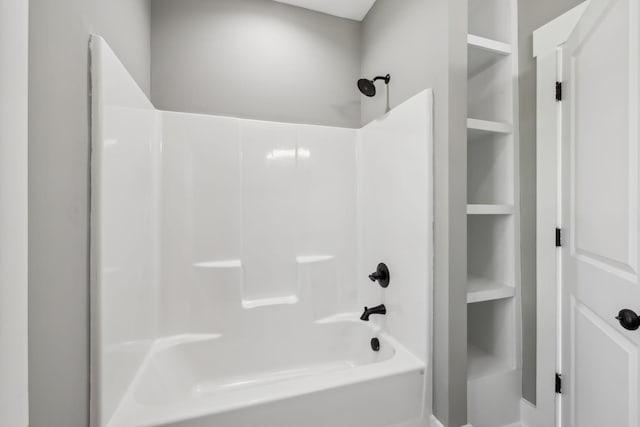 bathroom featuring bathing tub / shower combination and built in features