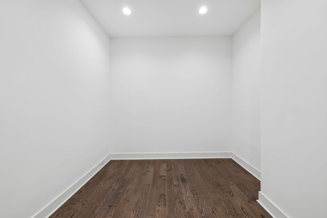 unfurnished room featuring baseboards, dark wood finished floors, and recessed lighting