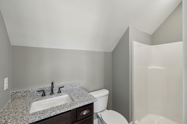 full bath with toilet, a shower stall, and lofted ceiling