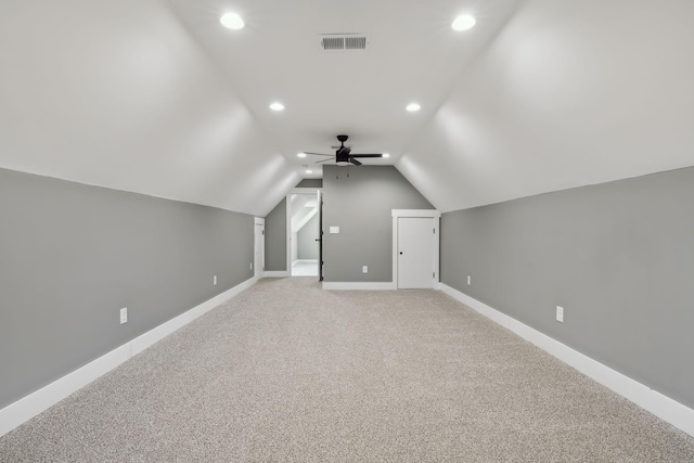 bonus room featuring ceiling fan, light carpet, visible vents, baseboards, and vaulted ceiling