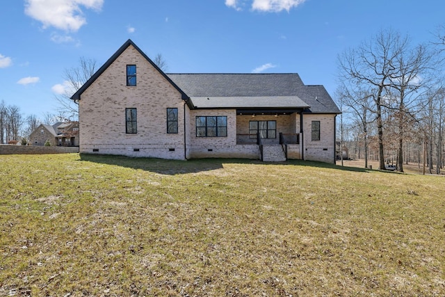 back of house with crawl space, roof with shingles, a lawn, and brick siding