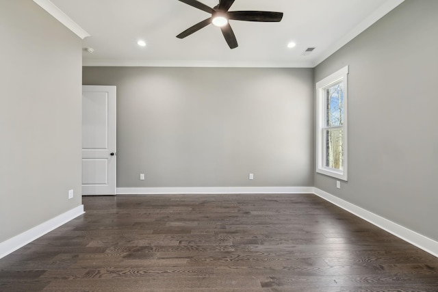 empty room with ornamental molding, dark wood-style flooring, visible vents, and baseboards