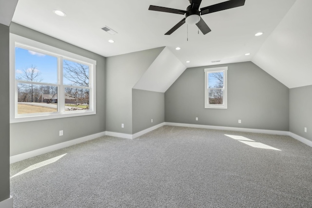 additional living space featuring light carpet, baseboards, visible vents, and vaulted ceiling