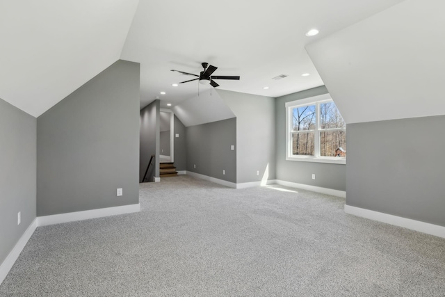 additional living space with a ceiling fan, vaulted ceiling, carpet floors, and baseboards