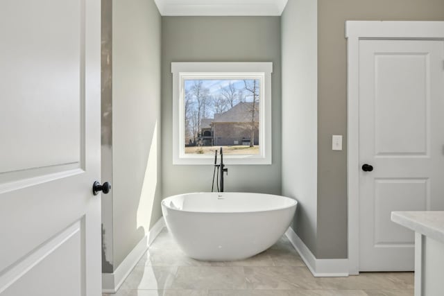 full bathroom featuring a soaking tub and baseboards