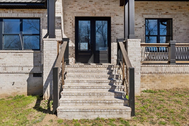 property entrance featuring brick siding