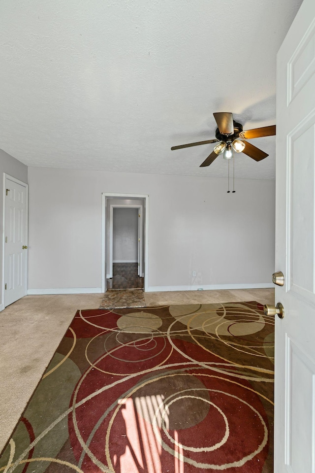 interior space with a textured ceiling and baseboards