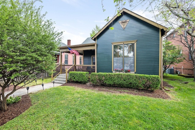 bungalow-style house featuring a front lawn, a chimney, and central AC unit