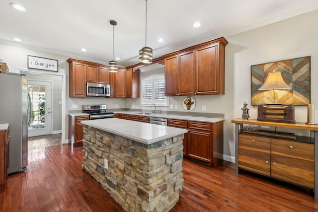 kitchen featuring a sink, light countertops, appliances with stainless steel finishes, plenty of natural light, and dark wood-style flooring