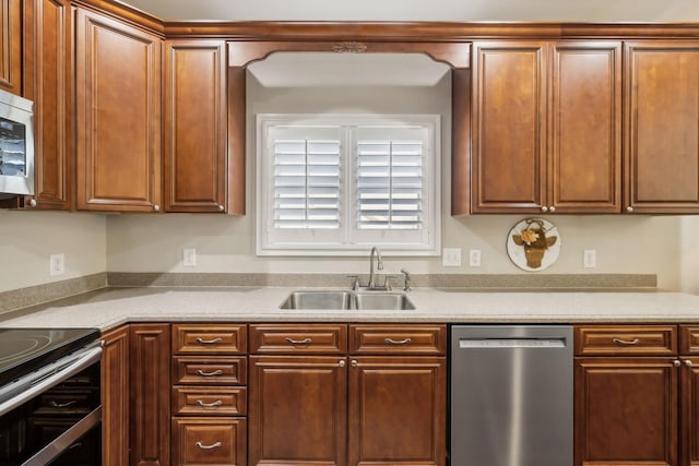 kitchen with light countertops, appliances with stainless steel finishes, and a sink