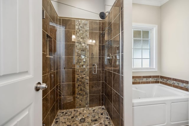 full bathroom featuring a garden tub, crown molding, and a stall shower