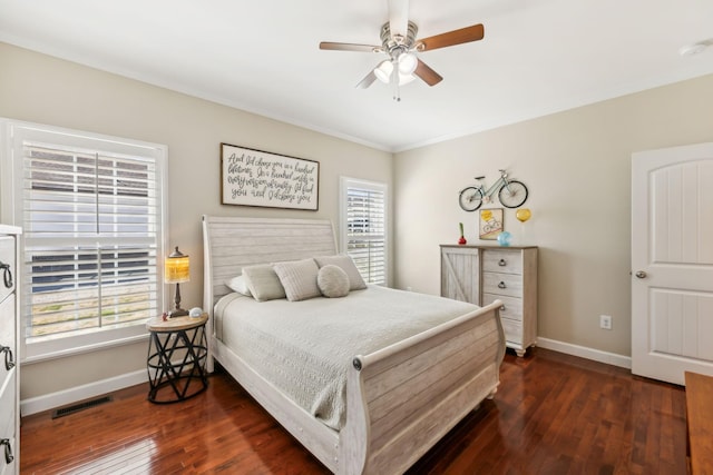 bedroom featuring visible vents, dark wood-type flooring, ornamental molding, a ceiling fan, and baseboards