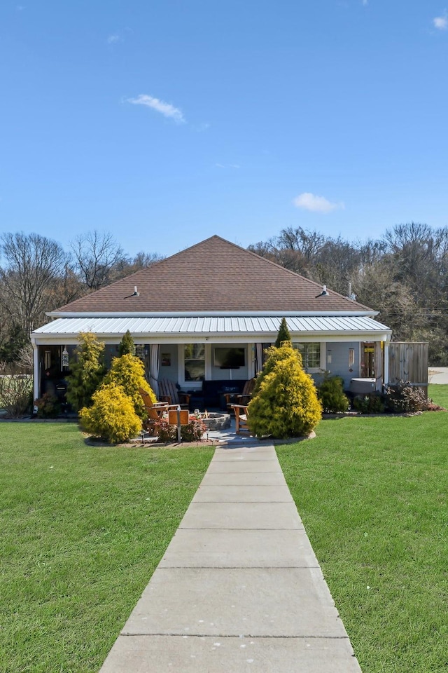 view of front of property with covered porch and a front yard