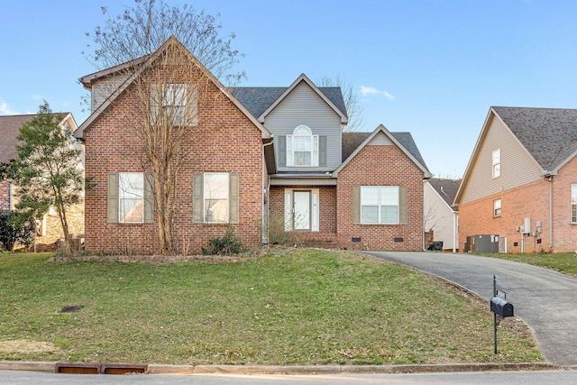 traditional-style house with crawl space, brick siding, driveway, and a front lawn