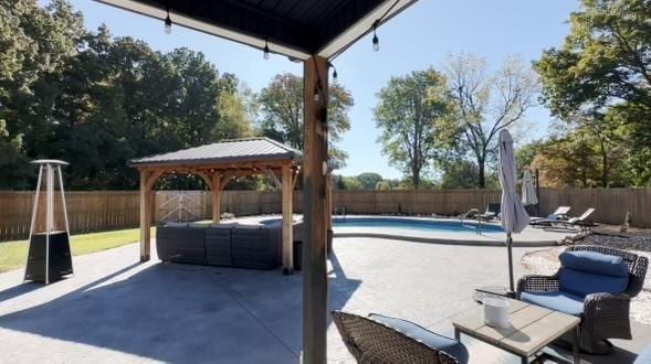 view of patio / terrace with a gazebo, a fenced backyard, and a fenced in pool