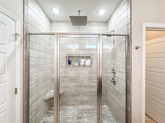 bathroom with a shower stall and recessed lighting