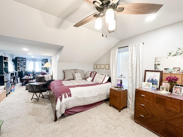 bedroom with lofted ceiling, ceiling fan, and light colored carpet