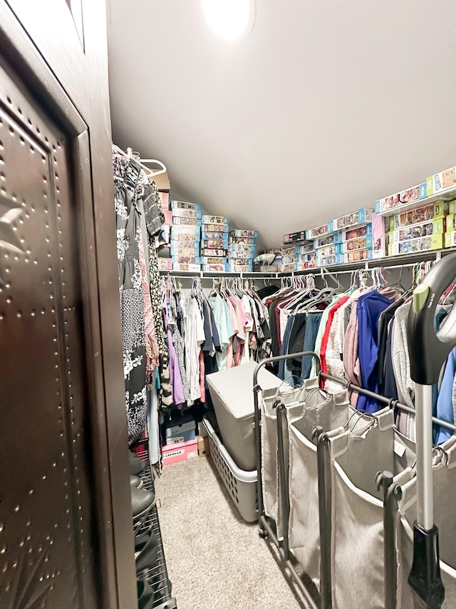 spacious closet featuring carpet and vaulted ceiling