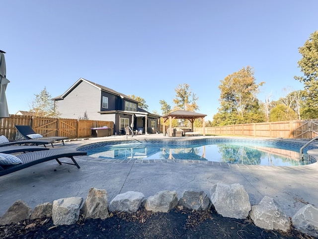 view of swimming pool featuring a gazebo, a patio area, a fenced backyard, and a fenced in pool