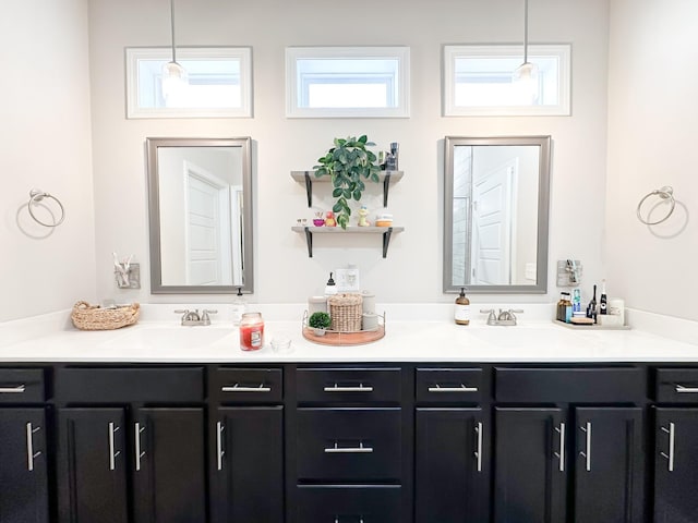 bathroom with a sink and double vanity