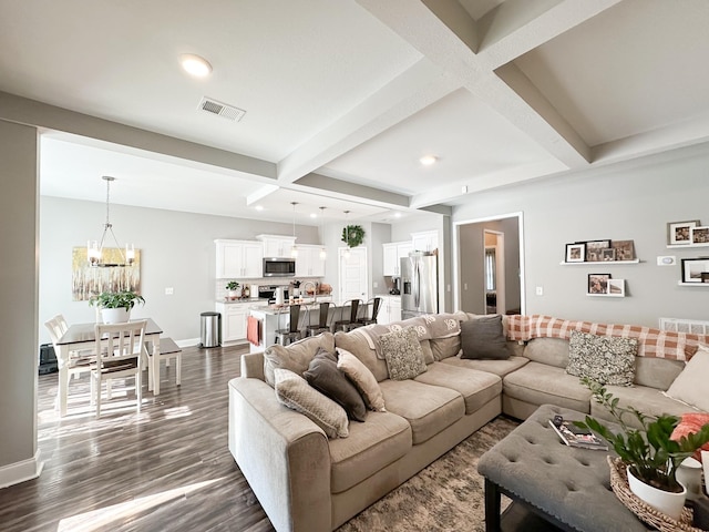 living area featuring baseboards, visible vents, dark wood-style floors, beamed ceiling, and a chandelier