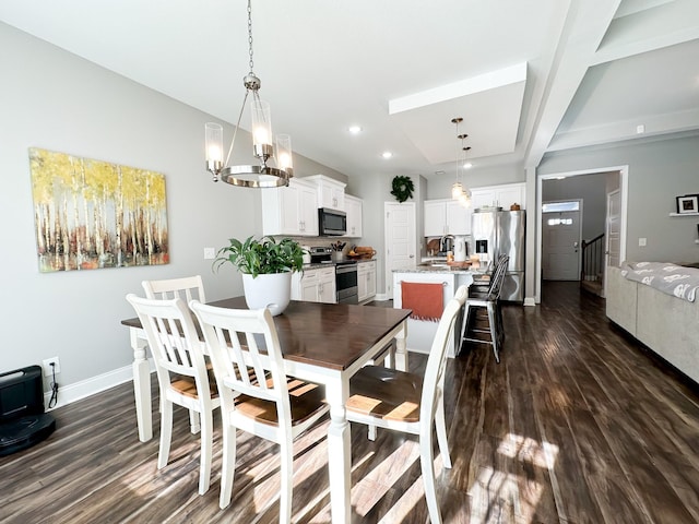 dining area with an inviting chandelier, dark wood finished floors, baseboards, and stairs