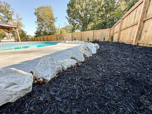 view of pool featuring a gazebo, a patio, a fenced backyard, and a fenced in pool