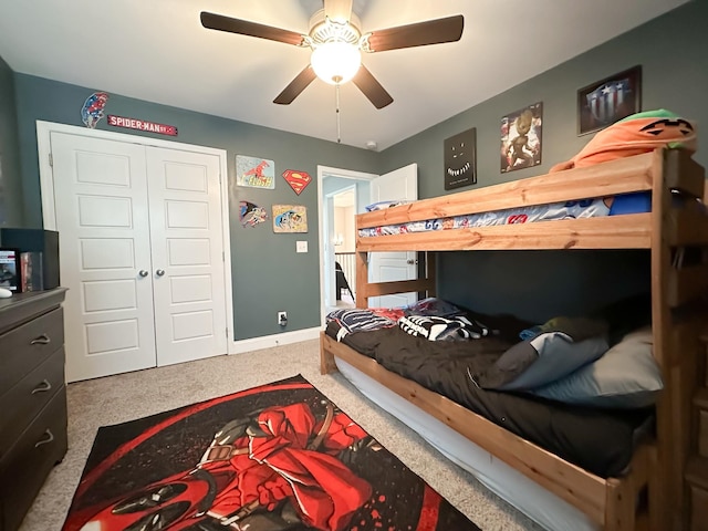 bedroom with carpet floors, a closet, a ceiling fan, and baseboards