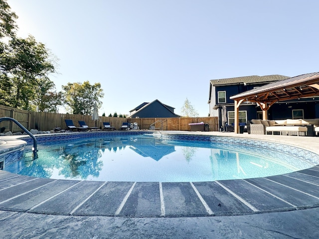 view of pool featuring a fenced in pool, a fenced backyard, a patio, and an outdoor living space