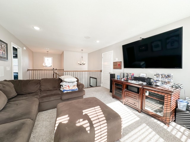 carpeted living area featuring a chandelier and recessed lighting