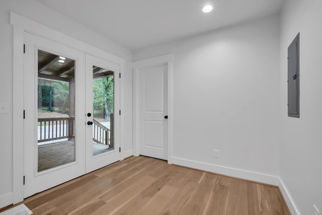 doorway featuring recessed lighting, baseboards, light wood-style floors, french doors, and electric panel