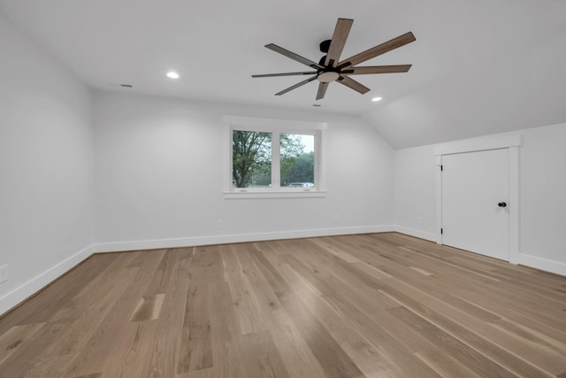 additional living space with lofted ceiling, light wood finished floors, baseboards, and recessed lighting