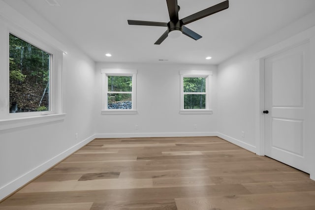 spare room with light wood-type flooring, baseboards, and recessed lighting