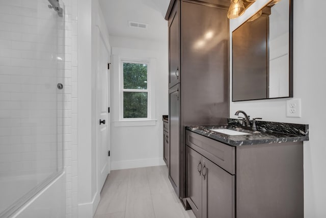 bathroom with vanity, visible vents, and baseboards