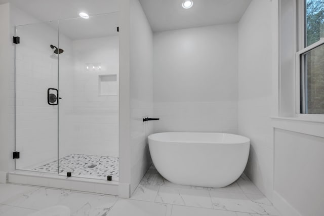 bathroom with a freestanding bath, marble finish floor, a stall shower, and recessed lighting