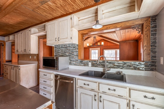 kitchen with a sink, wood ceiling, light countertops, appliances with stainless steel finishes, and decorative backsplash